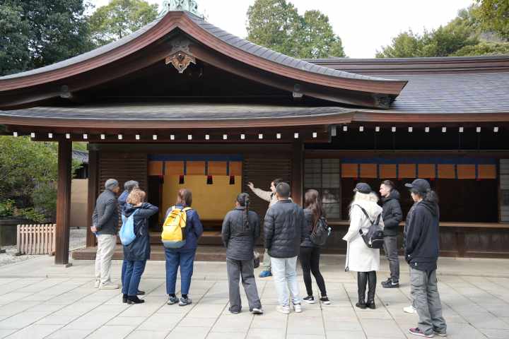 a group of people standing in front of Meiji Shrine