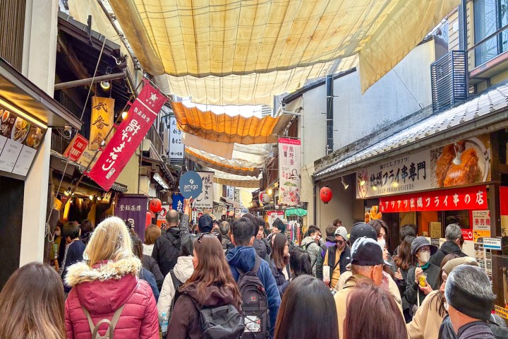 a group of people standing in front of a store