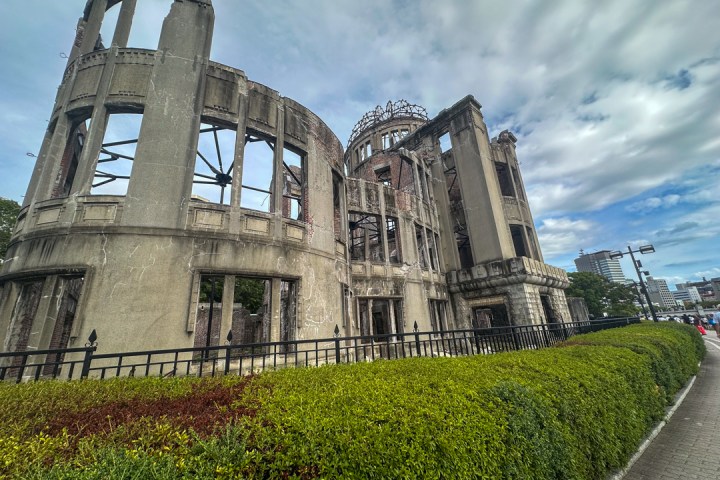 a large stone building with a tower in the background