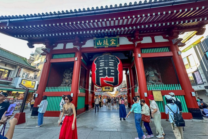 a group of people walking in front of Sensō-ji