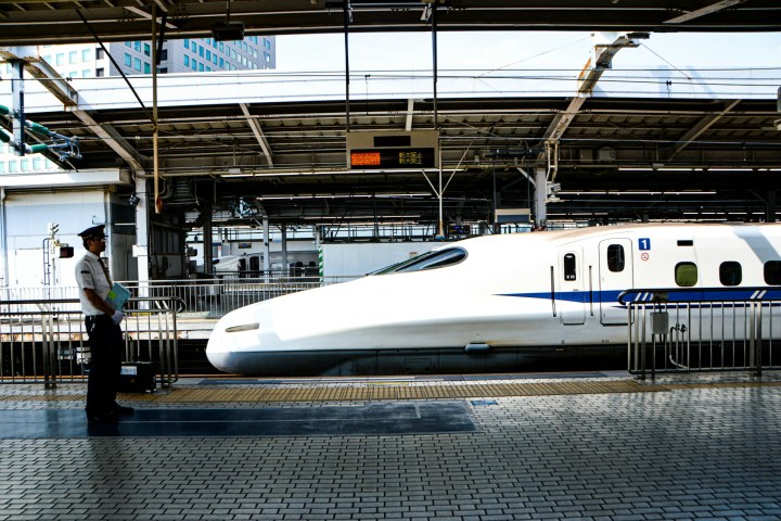 a large passenger jet sitting on top of a train station