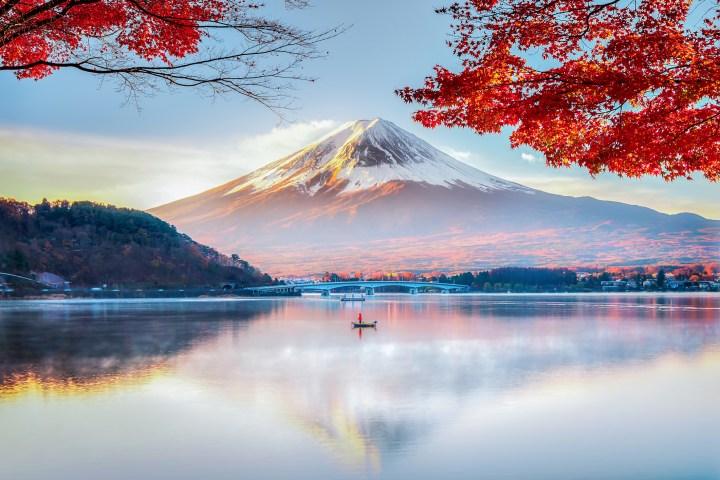 a large body of water with Mount Fuji in the background