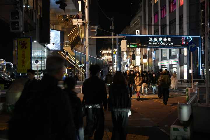 a group of people walking on a city street