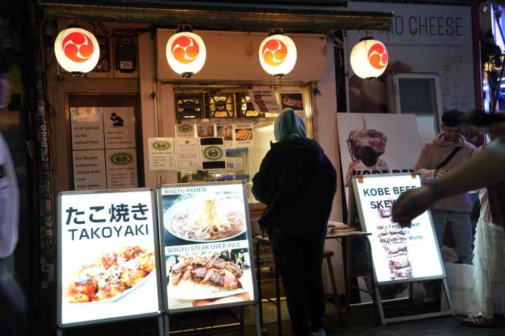 a group of people standing in front of a store