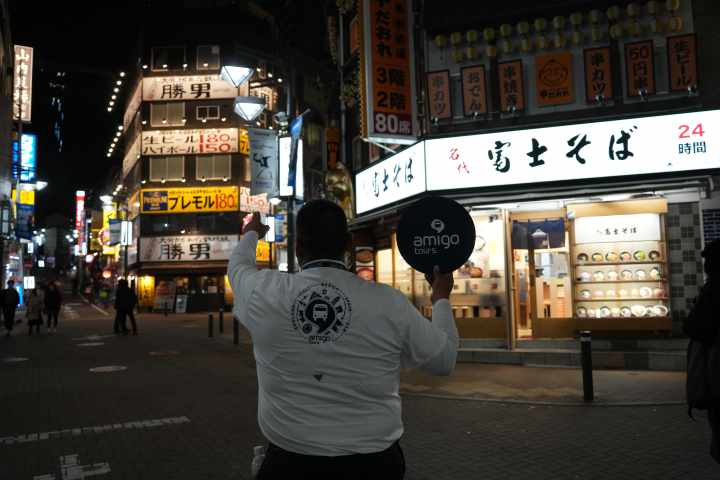 a group of people walking on a city street