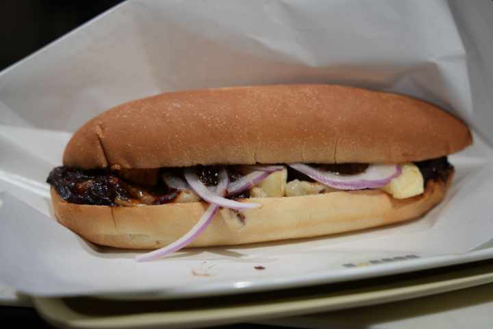 a close up of a sandwich sitting on top of a paper plate