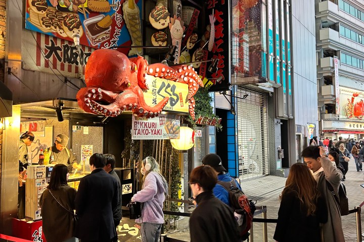 a group of people walking on a city street
