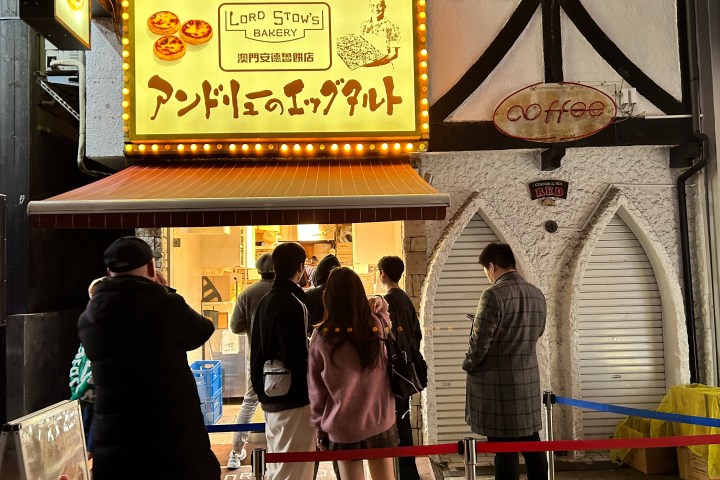 a couple of people that are standing in front of a store