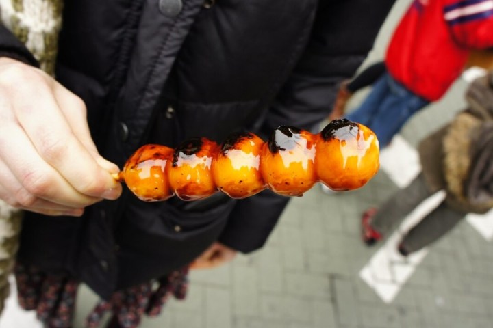 a person holding a hot dog