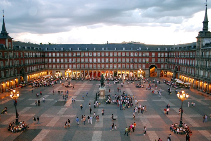 a group of people performing on stage in front of Plaza Mayor, Madrid