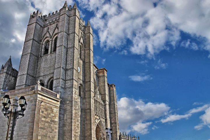 a large tall tower with a clock on the side of a building