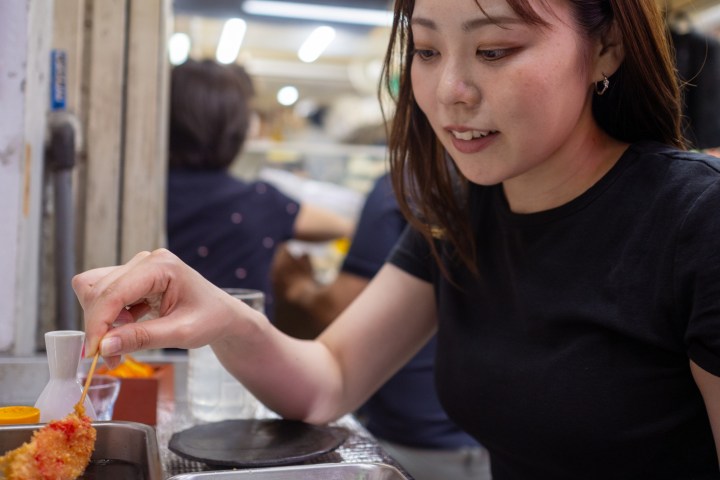 a woman preparing food in a kitchen