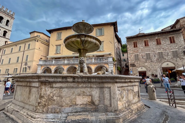 a large stone statue in front of a building