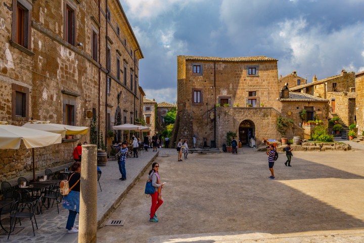 a group of people walking in front of a building