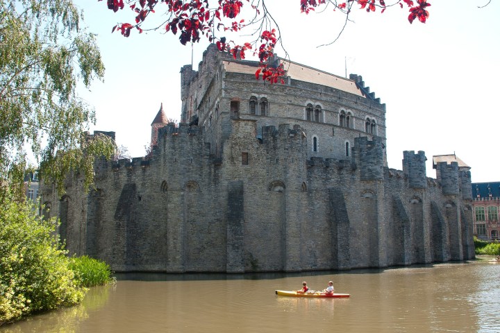 a castle with a boat in the water