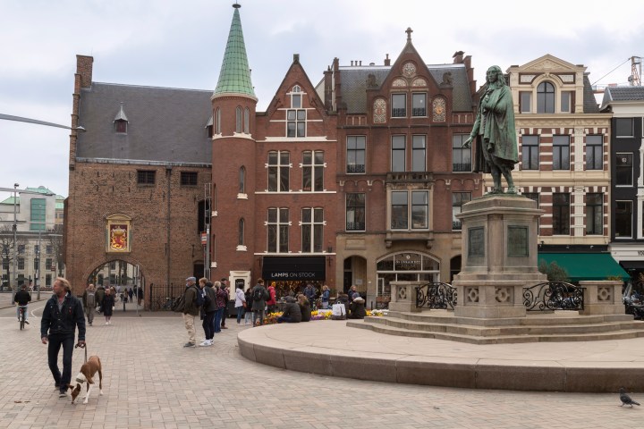 a group of people walking in front of a building