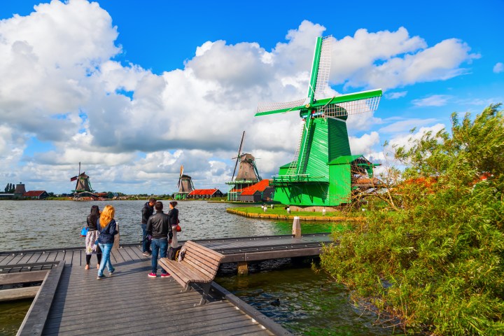 a group of people sitting at a dock