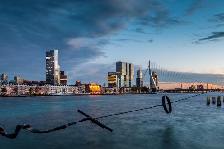 a boat on a body of water with a city in the background