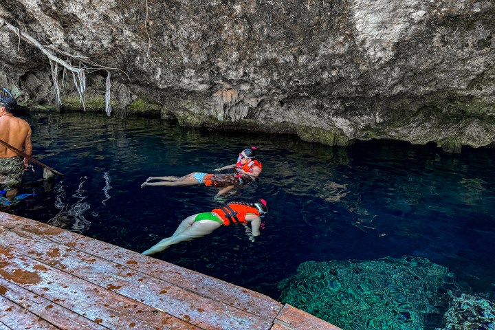 a group of people rowing a boat in the water