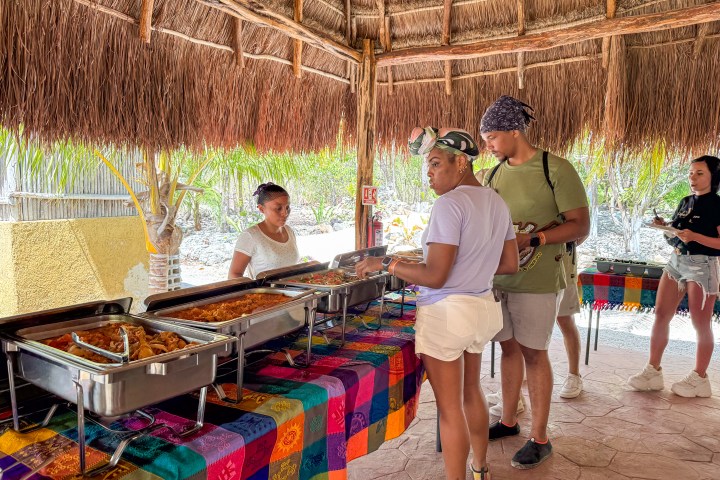 a group of people standing next to a fence