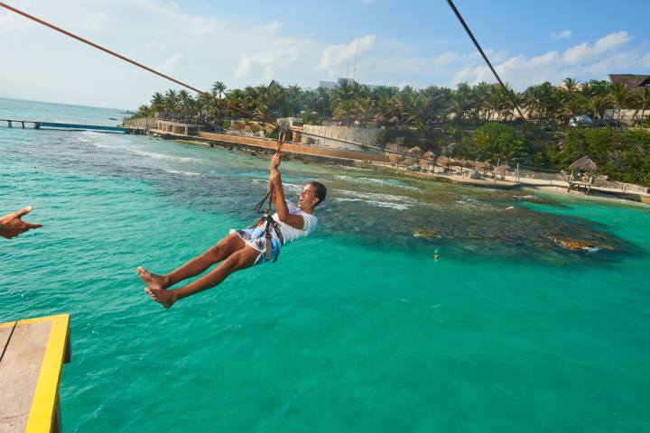 a group of people swimming in a pool of water