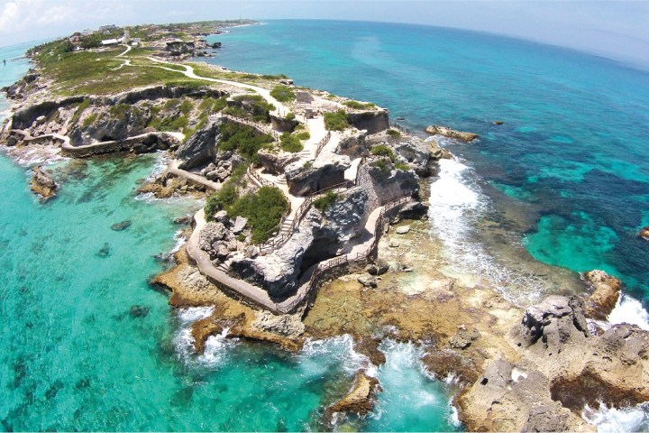 a rocky island in the middle of a body of water