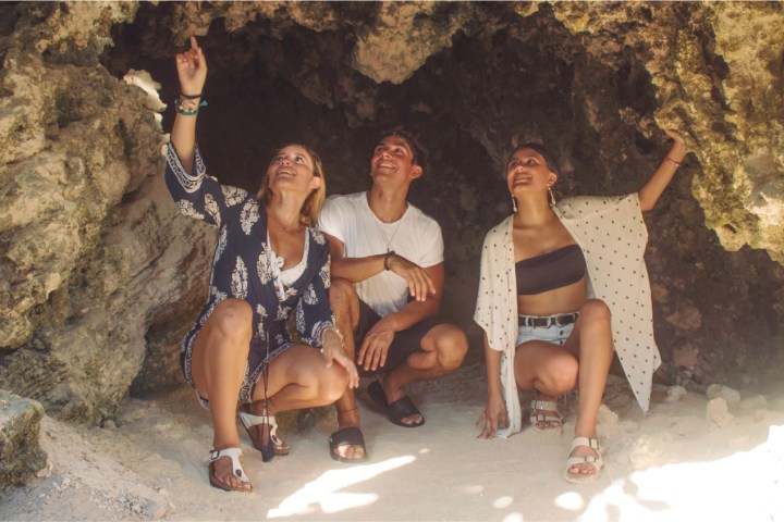 a man and a woman sitting on a rock