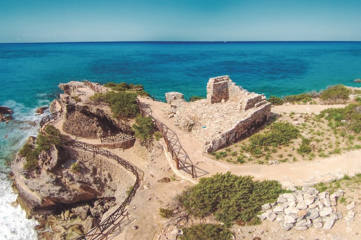 a close up of a rock next to a body of water