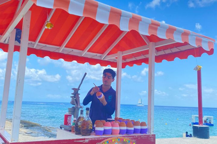 a man standing next to a body of water