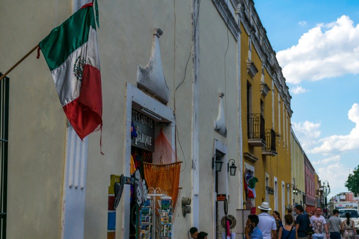 a group of people walking down a street next to a building