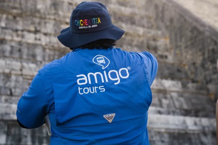 a person standing in front of a brick building