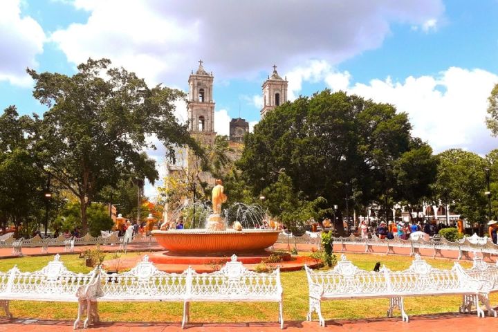 a group of people sitting at a table in front of a building