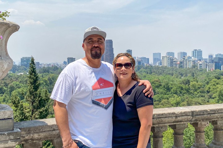 a man standing in front of a bridge