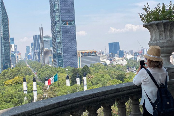 a group of people standing in front of a bridge